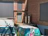 Property entrance with brick siding and a patio area