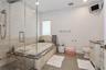 Full bathroom with separate shower and tub, vanity, and toilet