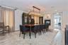 Dining area featuring a multi sided fireplace and light wood-type flooring