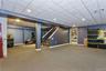 Basement with a drop ceiling and carpet