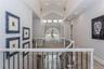 Hall with carpet floors and lofted ceiling