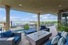 Deck with a water view, an outdoor living space, and a fenced in pool