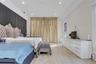 Primary on the main floor w/ French Doors behind gold curtain