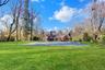 Back of property with a lawn and a chimney