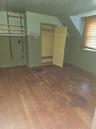 Additional living space featuring dark wood-style flooring, vaulted ceiling, and wood walls