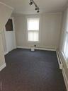 Bonus room featuring carpet and a baseboard radiator