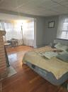 Bedroom featuring hardwood / wood-style flooring and baseboard heating