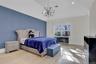 Bedroom featuring light wood-type flooring, a chandelier, and lofted ceiling