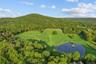 Land featuring large pond with gazebo. Approximately 20 of the 38 acres are contained with cedar, split rail fencing - all newly re-fenced in 2021.