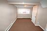 Empty room featuring a baseboard heating unit and carpet