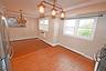 Unfurnished dining area featuring a chandelier, crown molding, hardwood / wood-style floors, baseboard heating, and recessed lighting