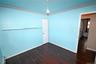 Unfurnished bedroom featuring crown molding and dark wood finished floors