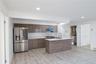 Kitchen with stainless steel appliances, light wood-type flooring, under cabinet range hood, modern cabinets, and recessed lighting