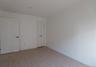 Spare room featuring light wood finished floors and baseboards