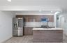 Kitchen with stainless steel appliances, tasteful backsplash, light stone countertops, recessed lighting, and modern cabinets