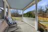 Porch featuring view of scattered trees