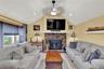 Living area with vaulted ceiling and a brick fireplace