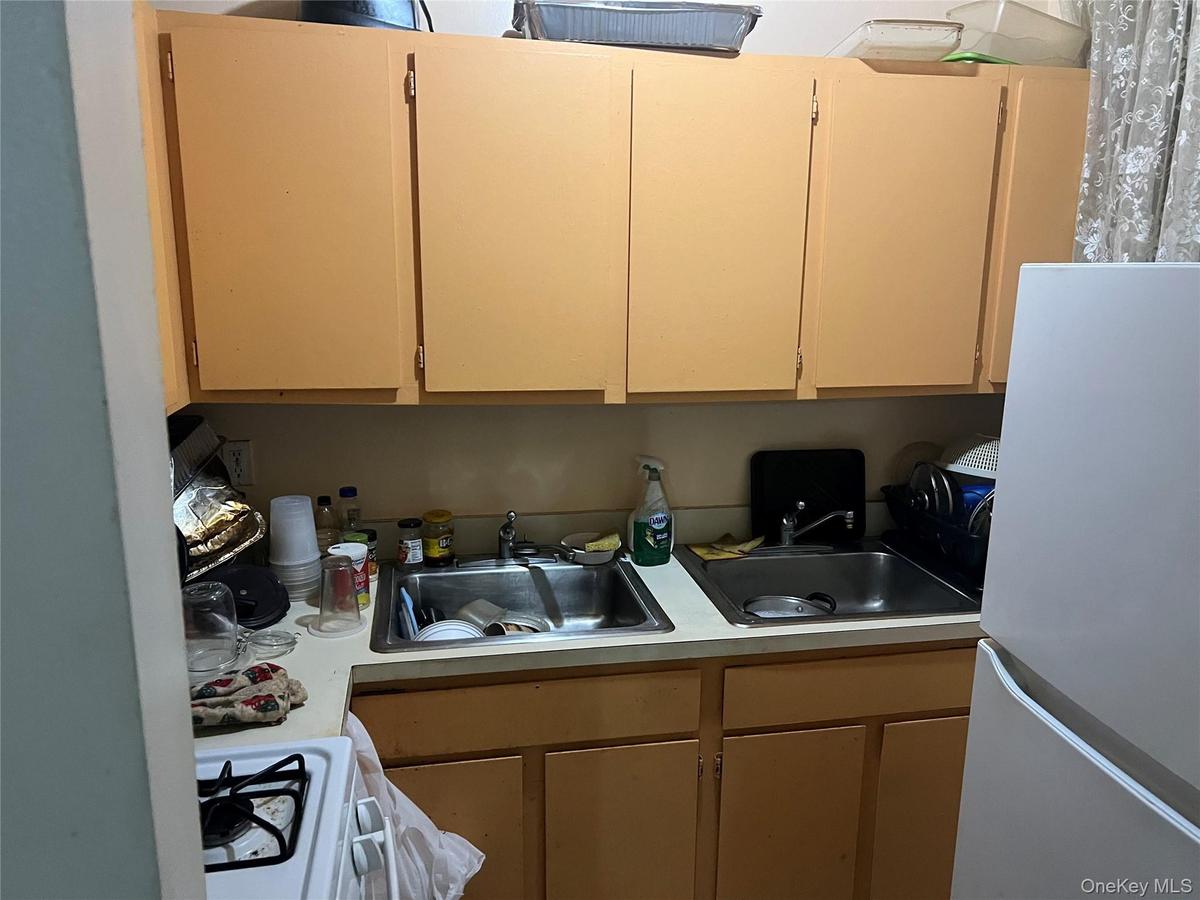 Kitchen featuring white appliances and light countertops