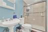 Full bathroom featuring crown molding and a shower stall
