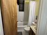 Full bathroom featuring shower / tub combo, vanity, and light tile patterned floors