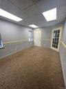 Unfurnished room with a drop ceiling and carpet floors
