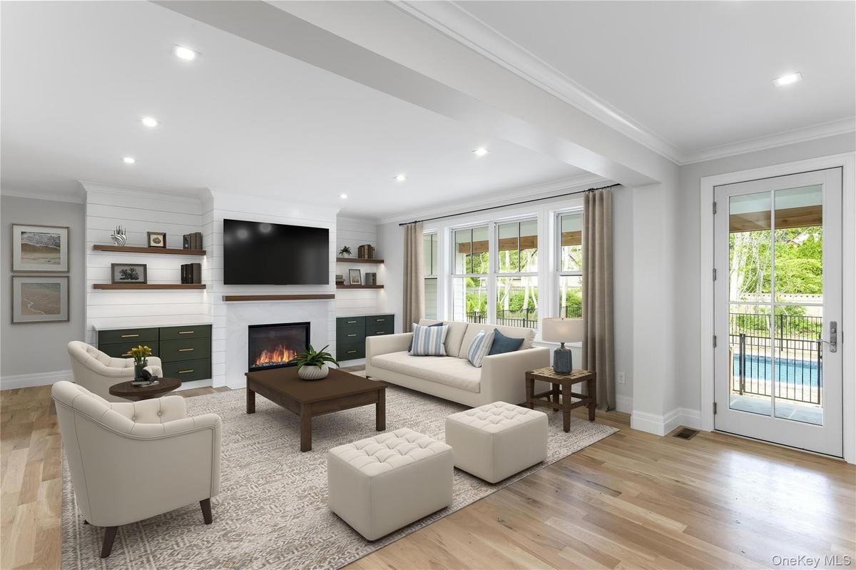 Great Rm Open Staged Concept living with a large fireplace, crown molding, light wood-type flooring, and recessed lighting