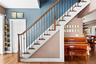 Entrance foyer featuring wood finished floors, stairway, and a chandelier