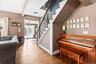 Stairs featuring wood finished floors and beamed ceiling