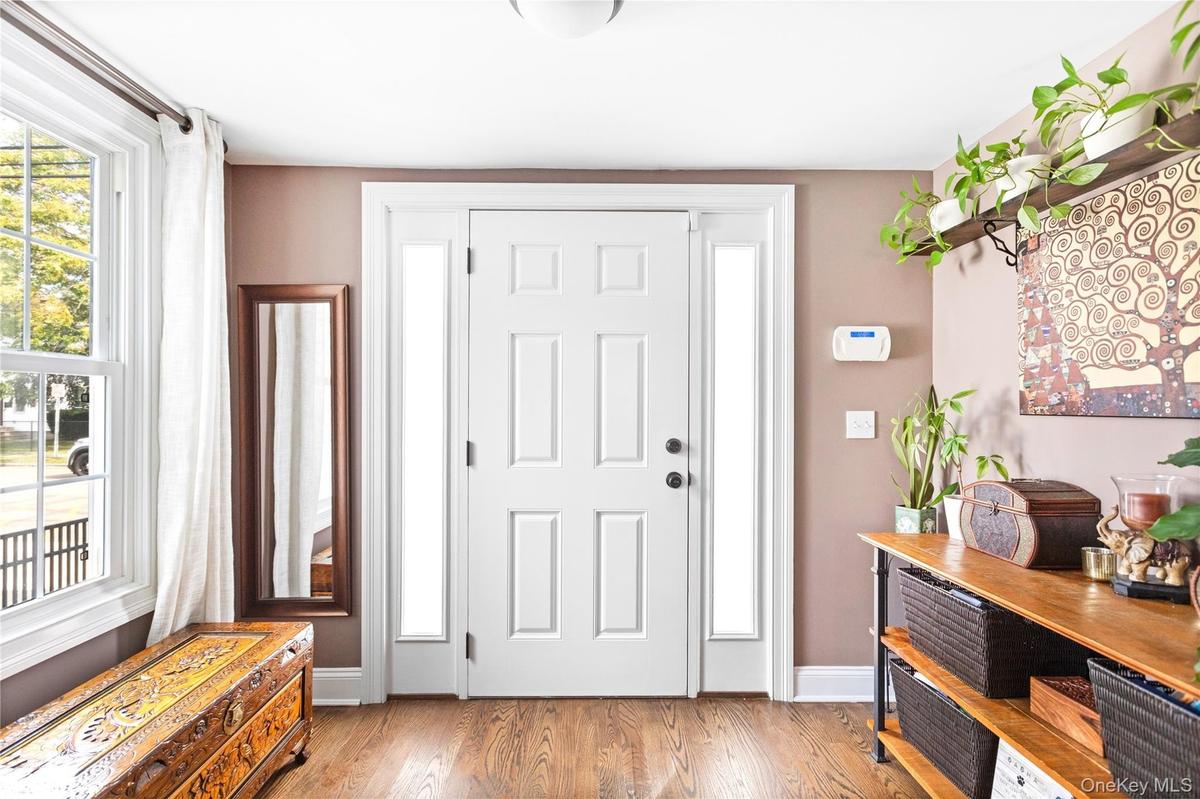 Foyer with wood finished floors and baseboards