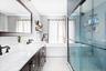 Full bathroom with double vanity, a shower stall, and a bathtub