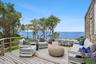 Wooden deck featuring an outdoor living space, a water view, and outdoor dining area