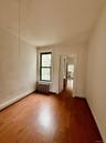Empty room featuring radiator and wood finished floors
