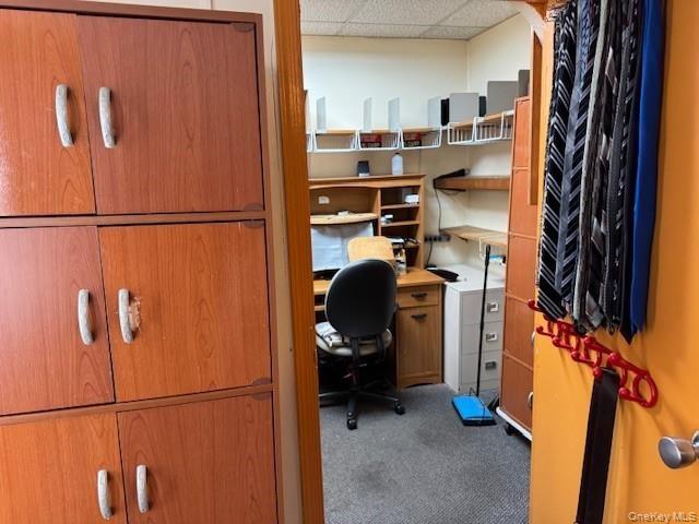 Carpeted home office with a drop ceiling