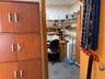 Carpeted home office with a drop ceiling