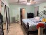 Bedroom featuring ceiling fan, rail lighting, and a closet