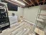 Finished below grade area featuring baseboards and light wood-style floors