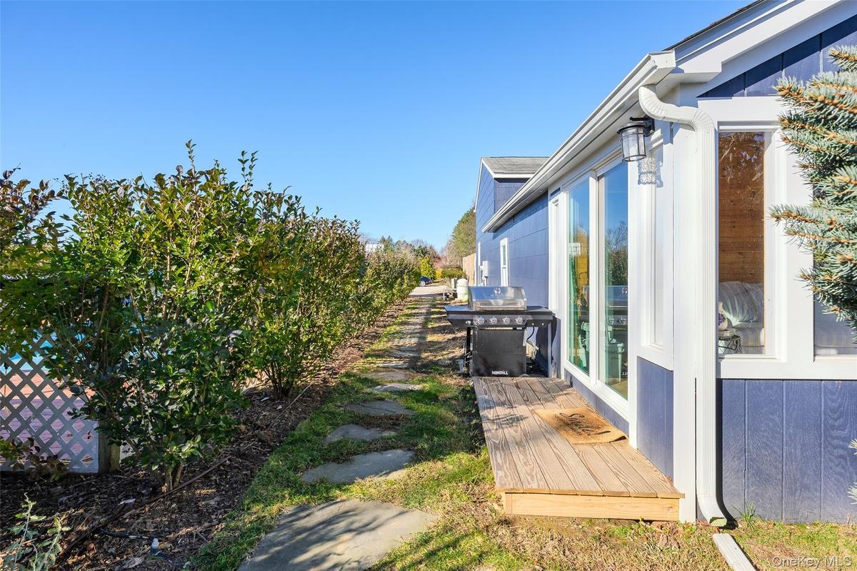 View of yard/outbuilding adjacent to pool & patio