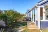 View of yard/outbuilding adjacent to pool & patio