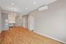 Unfurnished living room featuring a chandelier, light wood-type flooring, recessed lighting, and a wall mounted AC