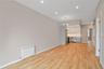 Unfurnished living room with radiator, recessed lighting, light wood finished floors, and a chandelier