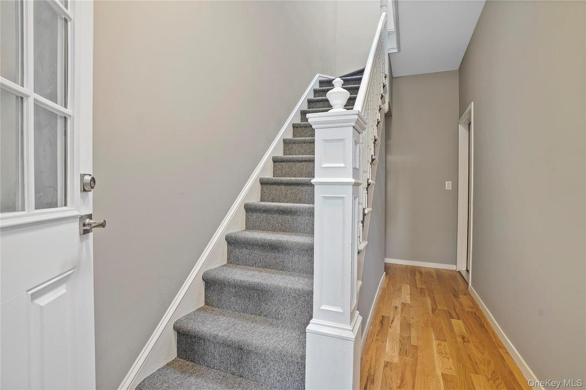 Stairs featuring wood finished floors and baseboards
