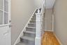Stairs featuring wood finished floors and baseboards