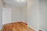 Spare room featuring light wood-style flooring and baseboards