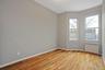 Spare room featuring radiator and light wood-type flooring
