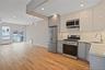 Kitchen with appliances with stainless steel finishes, light stone counters, tasteful backsplash, recessed lighting, and open floor plan