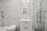Full bath with a marble finish shower, vanity, tile walls, and a tub to relax in