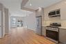 Kitchen featuring gray cabinetry, stainless steel appliances, tasteful backsplash, and recessed lighting