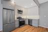 Kitchen with appliances with stainless steel finishes, modern cabinets, decorative backsplash, light wood-style flooring, and recessed lighting