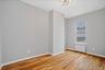 Unfurnished room with light wood-type flooring and radiator