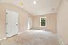 Unfurnished bedroom featuring baseboards and vaulted ceiling